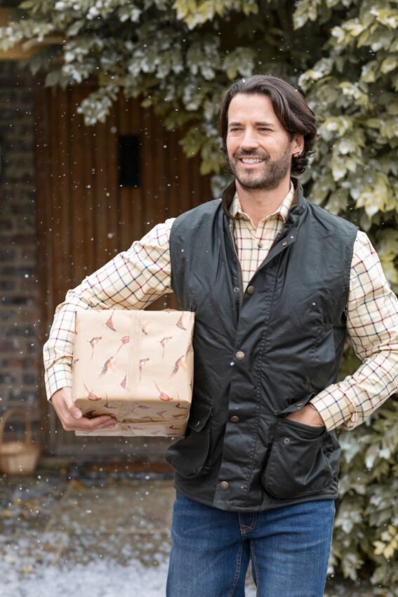 a man is holding a box in the snow