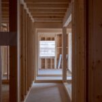 an empty room with wooden walls and beams