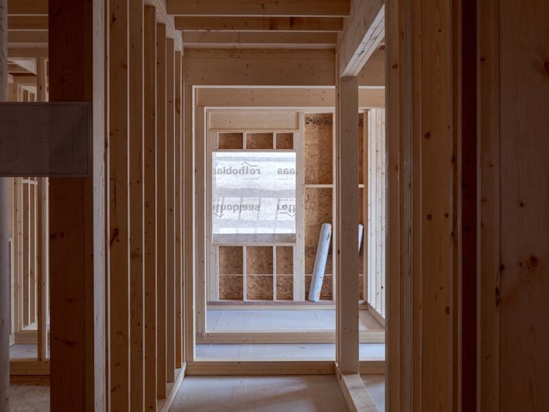 an empty room with wooden walls and beams