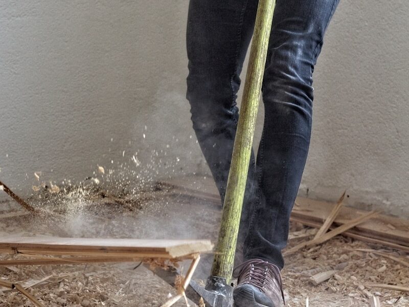 a man holding a large hammer in a room