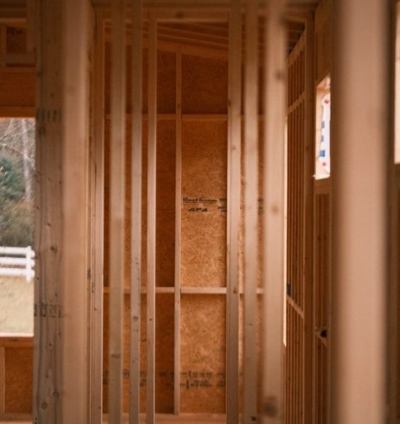 a room that is under construction with wooden framing