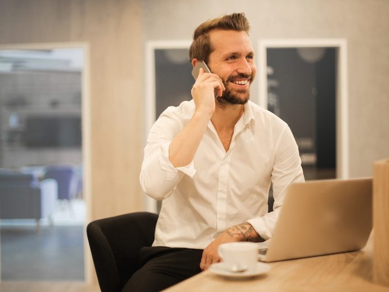 man using smartphone on chair