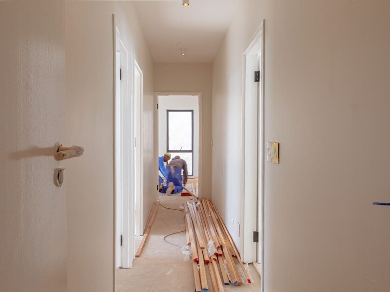 a couple of men working on a house