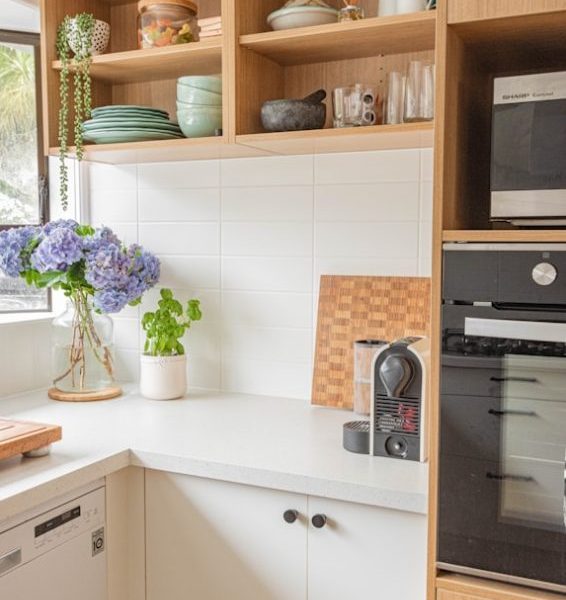 purple flowers in clear glass vase on white wooden table