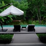 white patio umbrella near swimming pool