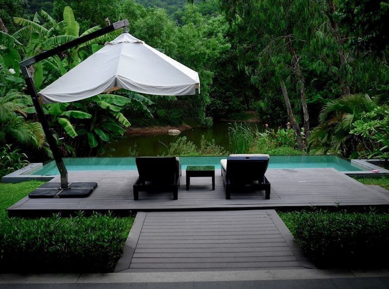 white patio umbrella near swimming pool