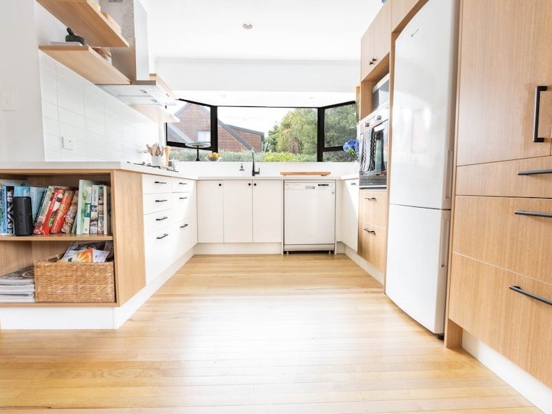 white dishwasher beside brown wooden kitchen cabinet