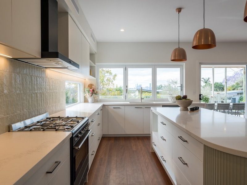 a kitchen with a stove top oven next to a window