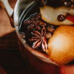 a pot filled with fruit and nuts on top of a table