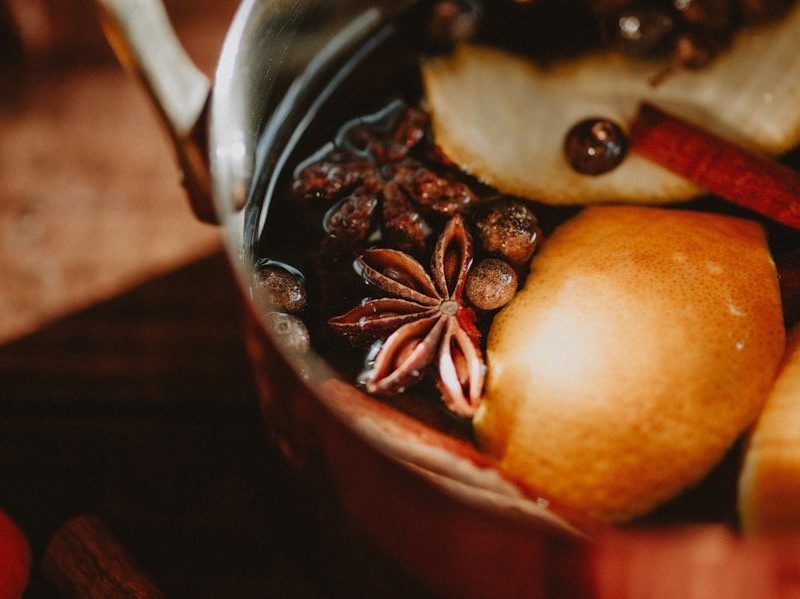 a pot filled with fruit and nuts on top of a table