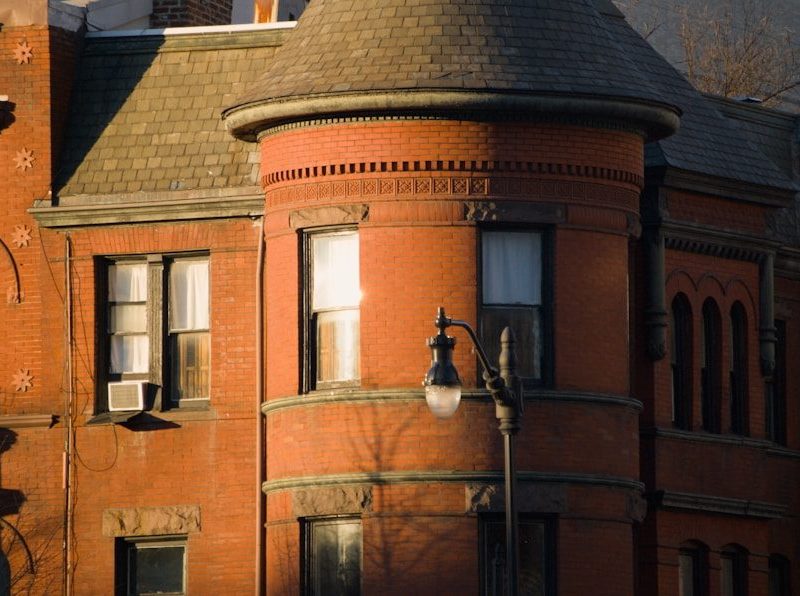 Close-up of a historic brick building with a turret.