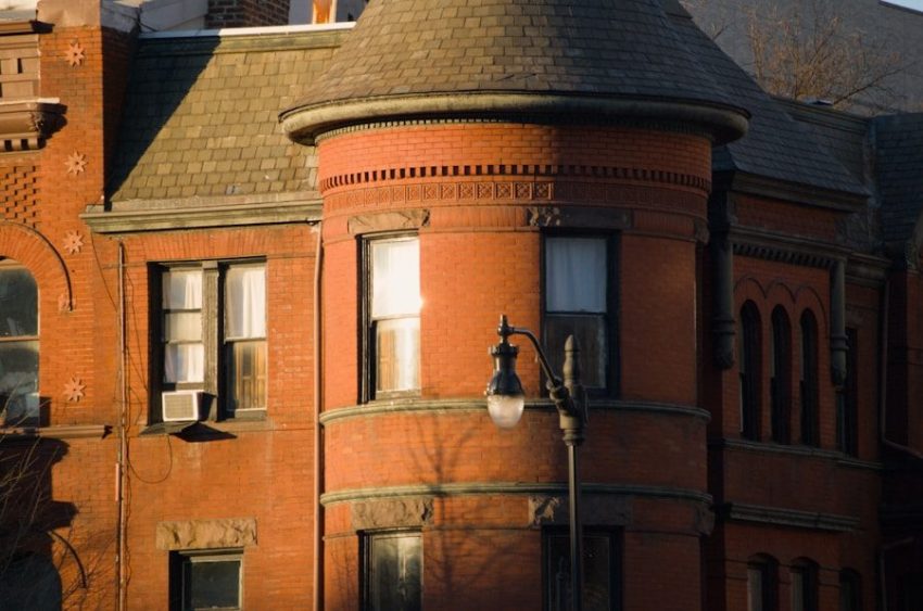 Close-up of a historic brick building with a turret.