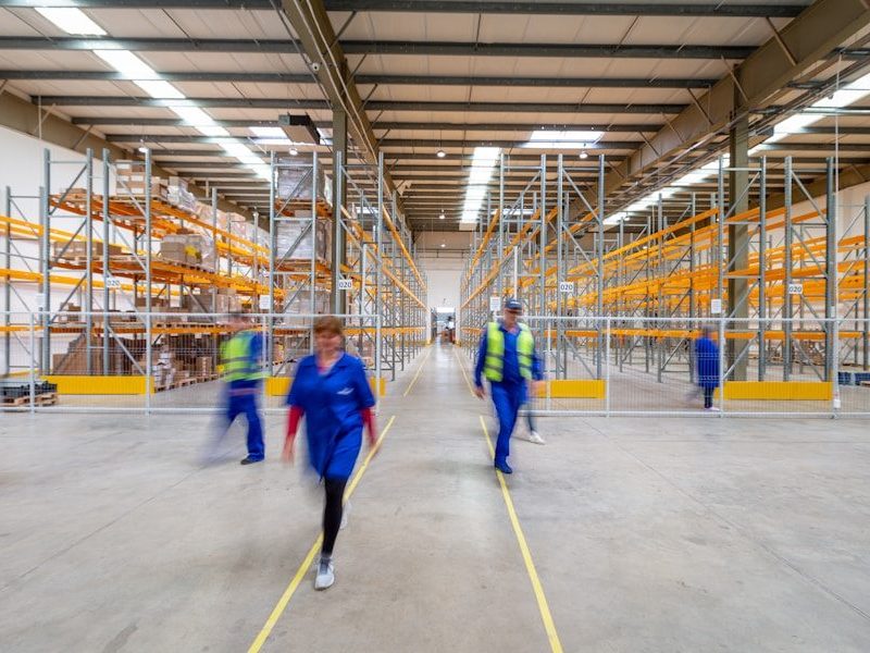 workers walking through warehouse aisle