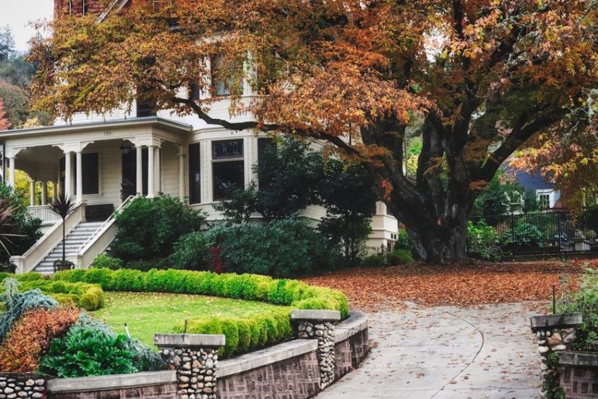 A large white house with a garden in front of it