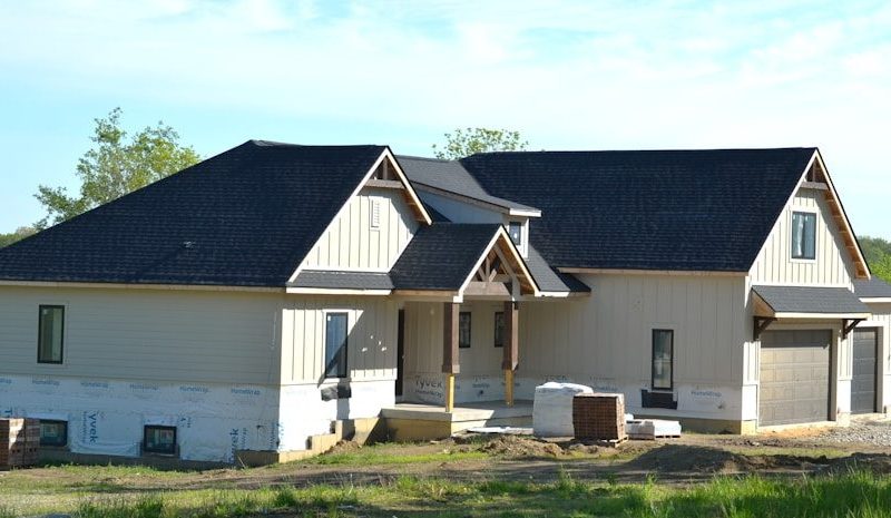 A new house under construction with a dark roof.