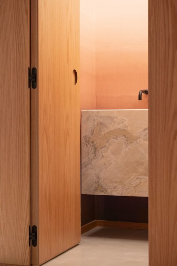 Modern bathroom with marble vanity and ombre wall.