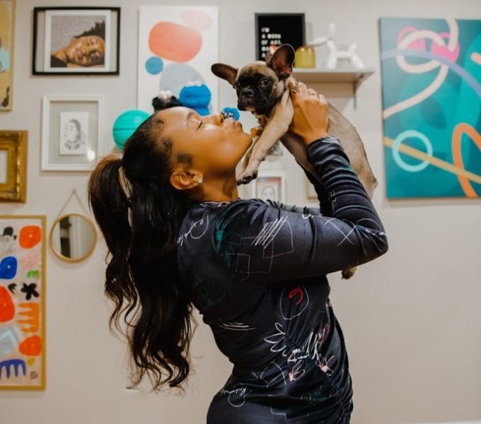 a woman holding a small dog in her arms