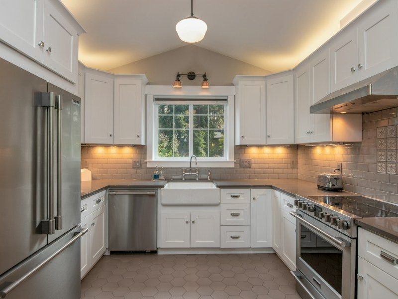 white wooden kitchen cabinet with white pendant lamp
