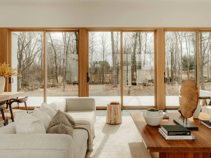 Modern living room with large windows overlooking trees