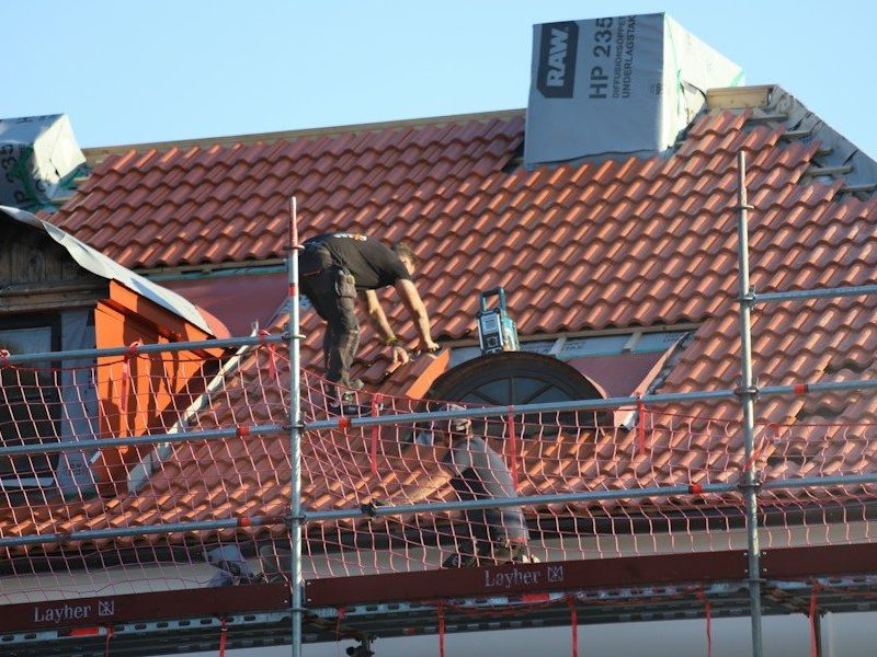 A man on a roof working on a roof