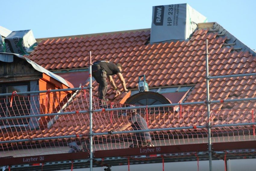 A man on a roof working on a roof
