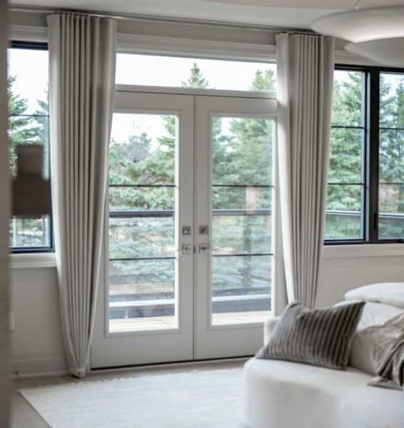Modern bedroom with large windows and balcony access